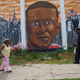 People walk past a mural of Freddie Gray in Baltimore on June 23, 2016, after Baltimore Police Officer Caesar Goodson Jr. was found not guilty on all charges regarding Gray’s death while in police custody.
Mark Makela/Getty Images